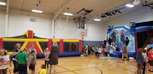 Students waiting to jump in bounce houses